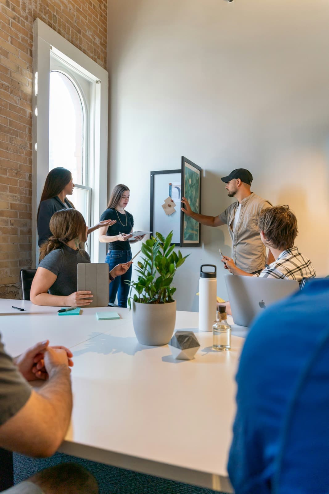 A team working through ideas pinned on the wall